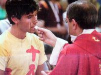 faithful priest receiving Communion