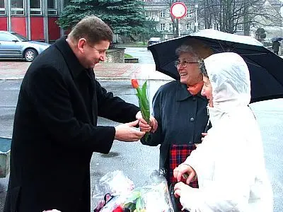 Kazimierz Sas wręcza kobietom tulipany