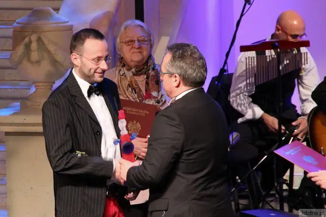 Krzysztof Gwizdała odbiera nagrodę z rąk prezydenta Piotra Romana