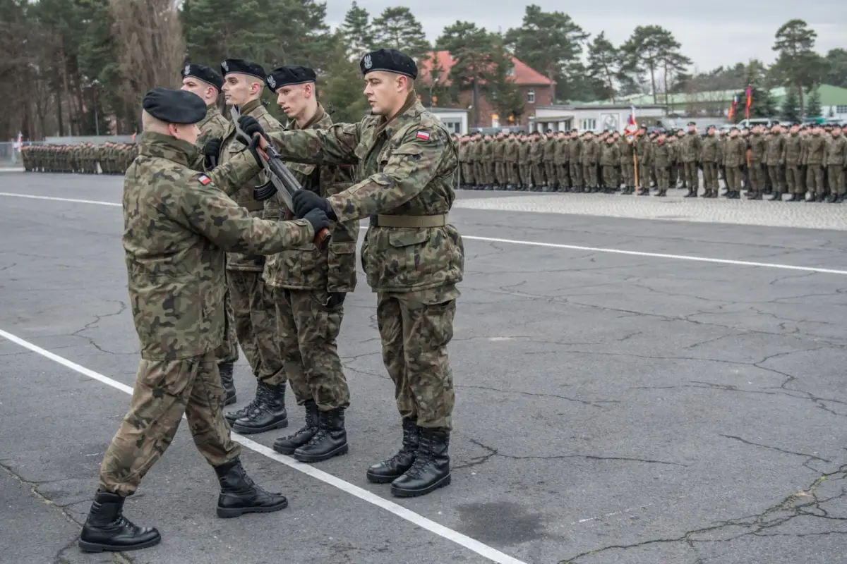 Armored soldiers ceremonially present weapons to recruits