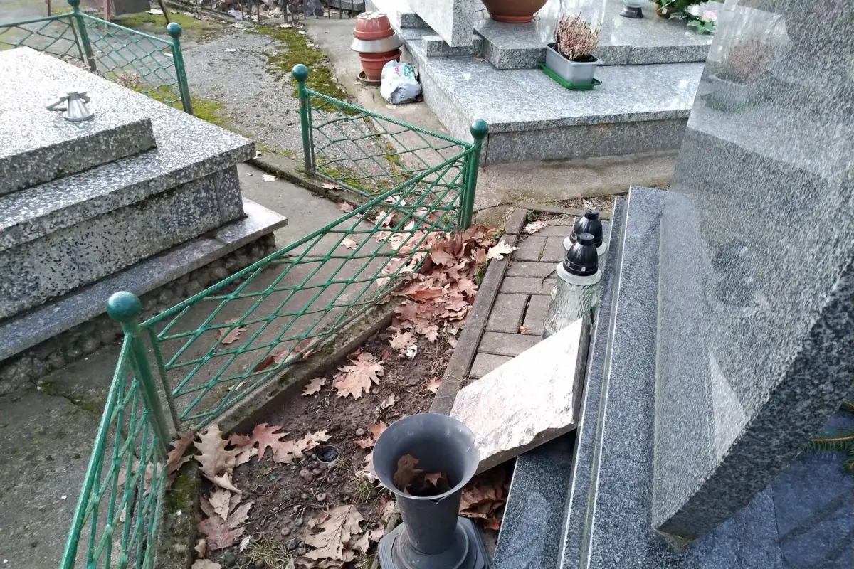 Nagrobek zadbany, a za nim schowane brudne szmaty i śmieci